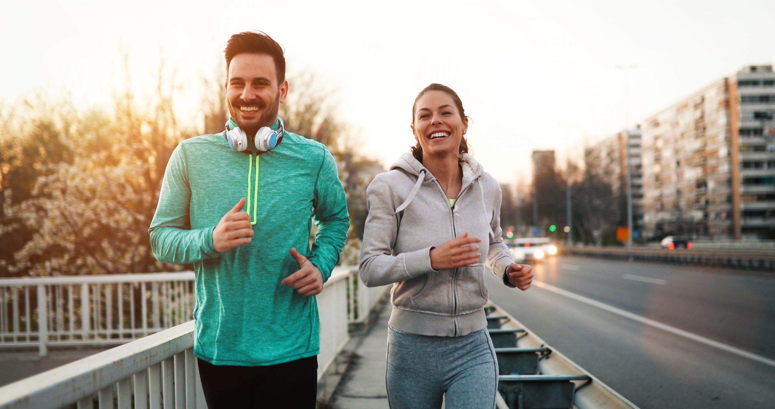 Young fitness couple running in urban area